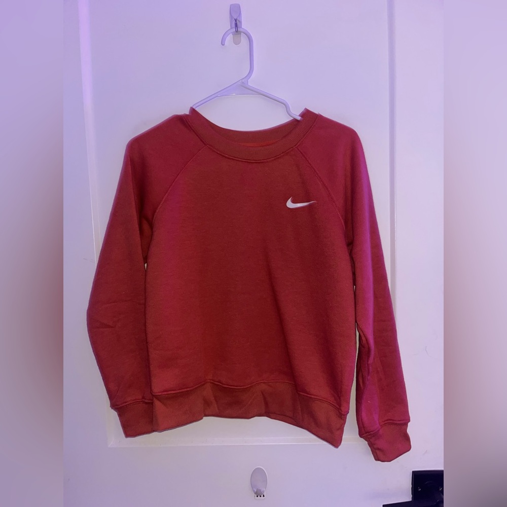 Coral color med unisex crewneck polyester sweater with a swoosh check mark on it